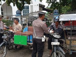 KBO Lantas Polres Aceh Utara Ipda Irvan Bagikan 101 Nasi Kotak kepada Tukang Becak dan Pedagang Kaki Lima